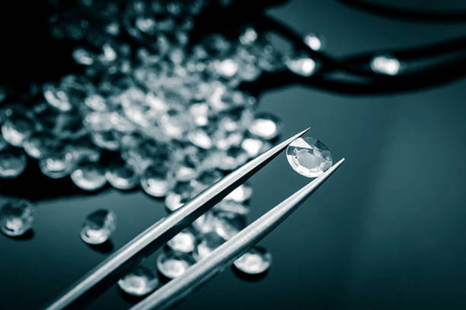 jeweler-observing-a-diamond-with-tweezers