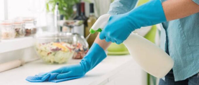 woman-cleaning-with-a-spray-detergent-kitchen